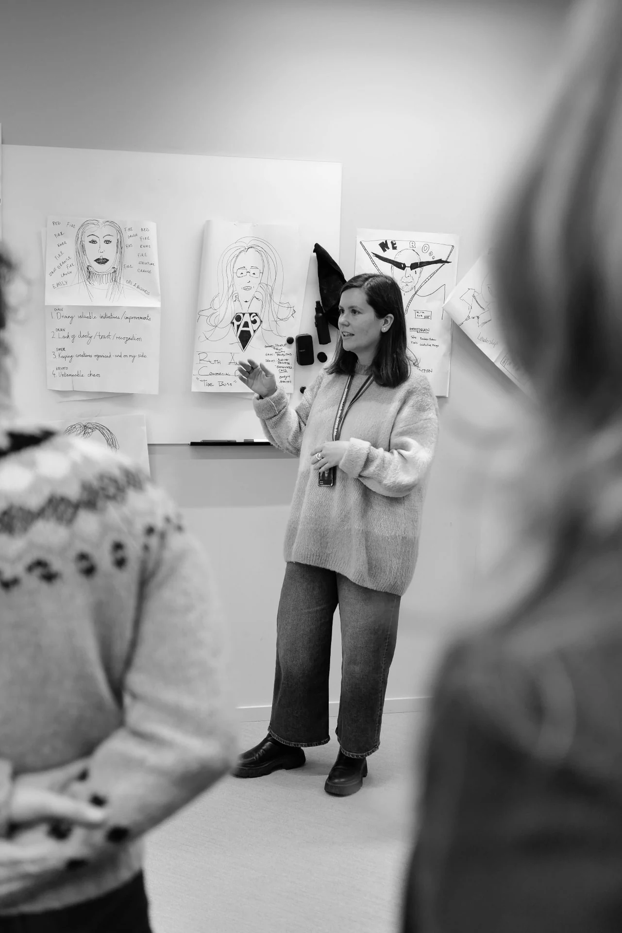 A workshop participant explaining a sketched profile to the room