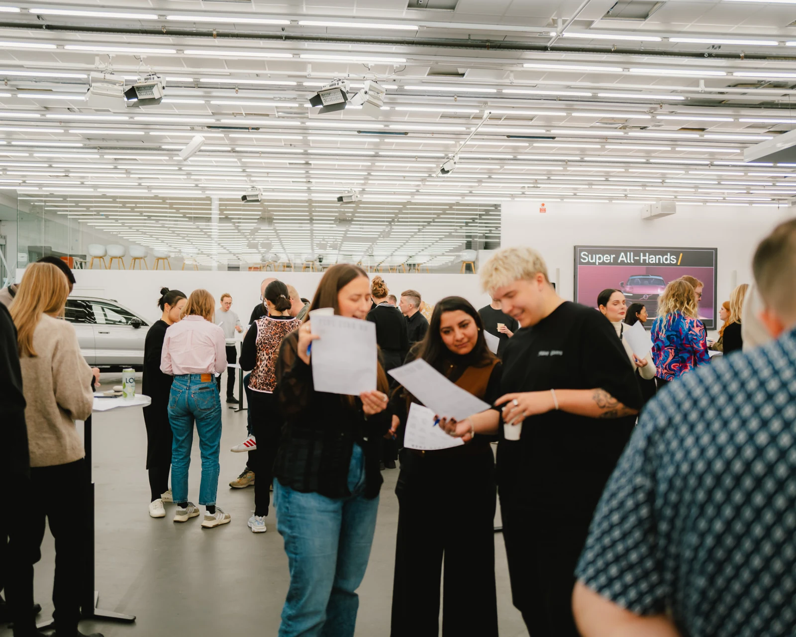 Colleagues gathered in the studio space during a Volvo all-hands